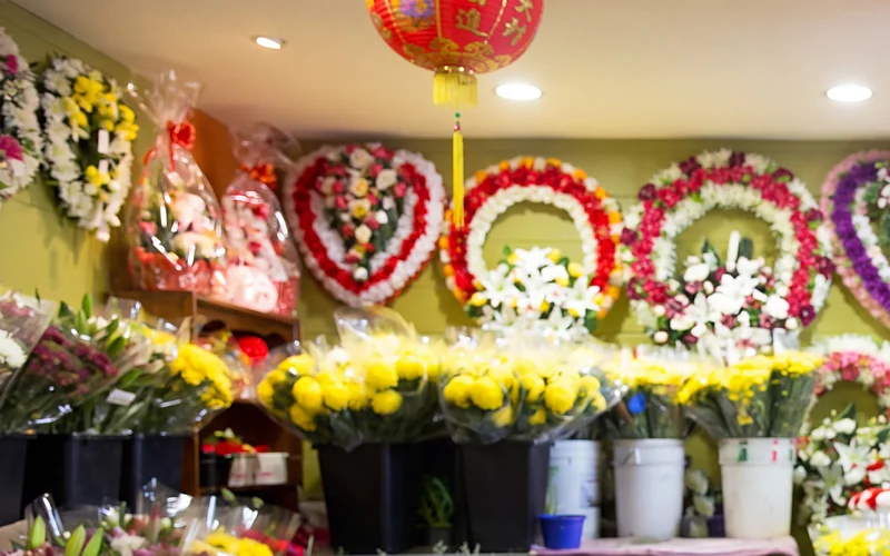 Heart and ring wreaths on the shop wall under red lanterns