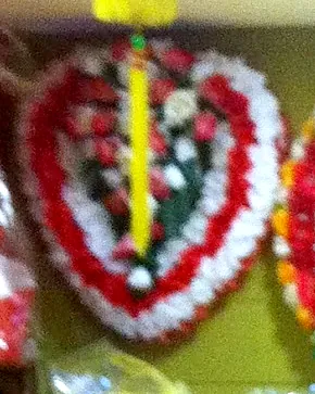 A heart wreath of red and white carnations